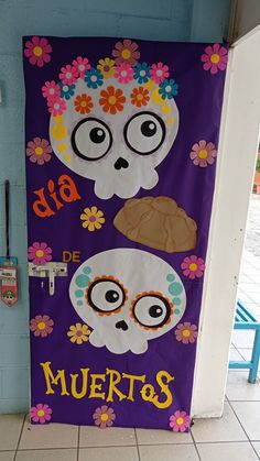 a door decorated with skulls and flowers on the front entrance to a school in mexico