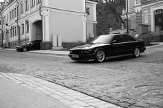 a black car parked on the side of a road