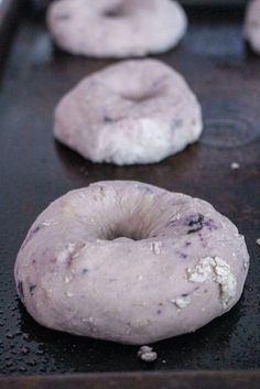 doughnuts sitting on top of a baking sheet