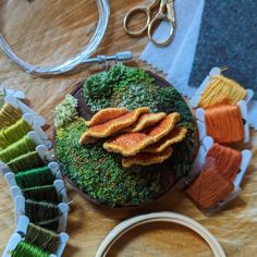 a table with scissors, yarn and other crafting supplies on top of the table