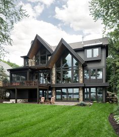 a large house sitting on top of a lush green field