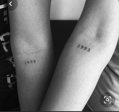 two people with matching tattoos on their arms, one has the year 1994 and the other is 1989