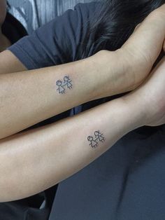 two people with matching tattoos on their arms