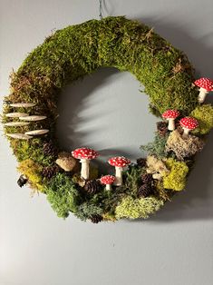 a wreath made out of moss and mushrooms