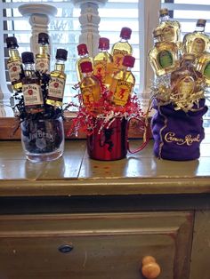 three bottles of liquor sitting on top of a table