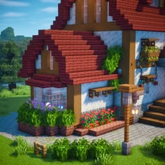 a very nice looking house in the middle of some flowers and plants on the outside