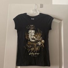 Super Cute Design Of Biker Betty Boop In A Sepia Tone Print. Junior Cut With Cap Sleeves Scoop Neck. Never Worn. Size: L (Junior Cut) 100% Cotton Biker Betty Boop, Betty Boop Black, Betty Boop T Shirt, Shopping Clothes, Cut T Shirt, Cut Tshirt, Cute Design, Betty Boop, Cute Designs