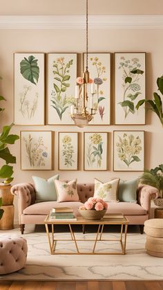 a living room with pink couches and paintings on the wall above them, along with a coffee table surrounded by potted plants