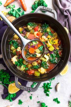 a pot filled with vegetable soup on top of a table