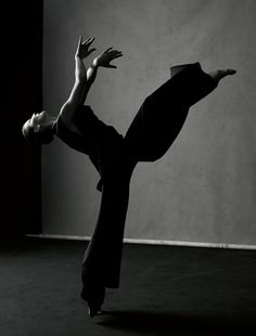 a woman is doing a handstand on the floor in black and white photo