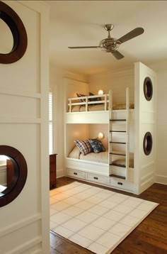 there is a bunk bed in the corner of this room with two mirrors on the wall