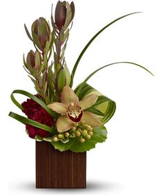 an arrangement of flowers in a wooden vase