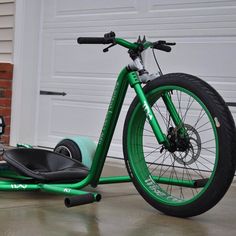 an electric scooter is parked in front of a garage door with the wheel on it