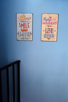 there are two signs on the wall above a crib