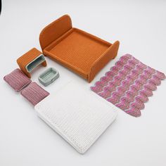 an assortment of knitted items displayed on a white surface