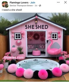 a hot tub in front of a pink shed with flamingos on the floor and decorations around it