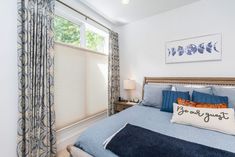 a bedroom with blue bedding and curtains