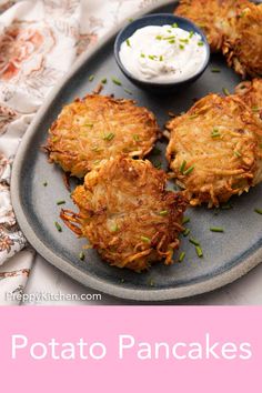 potato pancakes on a plate with sour cream and chives in the background text reads potato pancakes