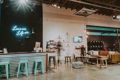 the interior of a furniture store with lots of tables and stools in front of it