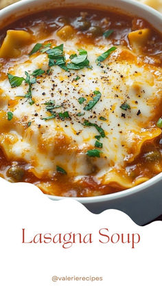 lasagna soup with cheese and herbs in a white bowl