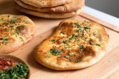 some pizzas are sitting on a cutting board