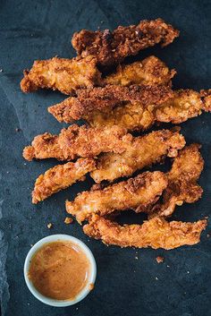 fried chicken sticks with dipping sauce on the side