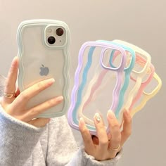 a woman holding up her phone case with multiple colors