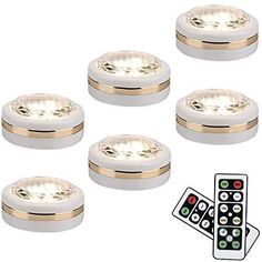 six white lights with gold trims and remote controls for the light on each side