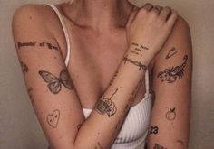 a woman with many tattoos on her arms