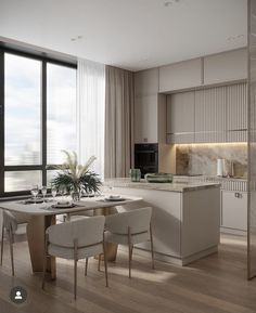 a modern kitchen and dining room with large windows