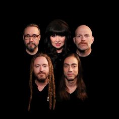 five people with long hair and beards posing for a photo