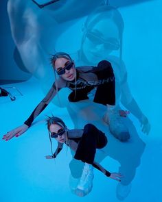 two women are posing in front of a mirror with their hands on their hipss