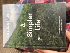 a person holding a book in their hand with the title'a life under a tree '