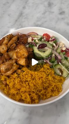 a bowl filled with rice, meat and veggies on top of a table