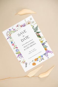 an image of save the date card with flowers and leaves around it on a beige background