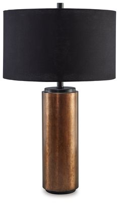 a table lamp with a black shade on the base and a gold metal container underneath it