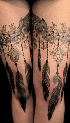 thigh tattoos with feathers and beads on the legs, one is made up of lace