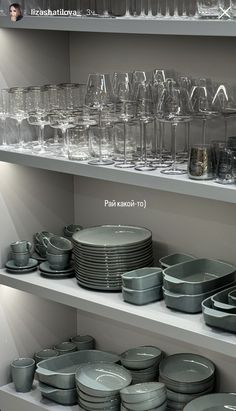 the shelves are filled with dishes and glasses