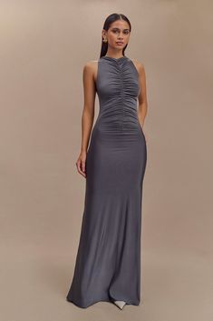 Sleek and sophisticated. The PRIYA Slinky Ruched Halter Maxi Dress is designed for the modern minimalist. With a refined racer front and back neckline, this sleeveless dress embodies effortless elegance. The front and back ruching detail enhances its bodycon silhouette, while the maxi length adds a touch of drama. Fully lined for a smooth finish, this maxi dress is a perfect choice for evening occasions where simplicity speaks volumes.