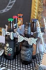 there are many bottles and glasses on the table with black and white polka dot paper