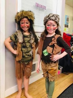 two children dressed in costumes standing next to each other