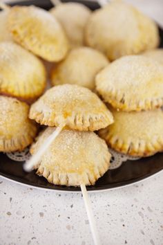 several pastries on a plate with toothpicks in them