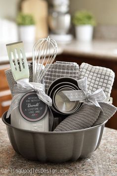 a metal pan filled with kitchen utensils on top of a counter