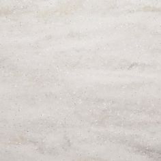 a white marble background with small speckles in the center and on the outside