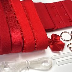 red ribbon, scissors and other accessories laid out on a table