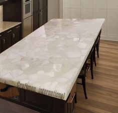 a large kitchen island with marble counter tops