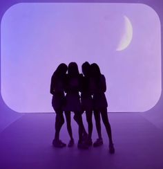 three girls are standing in front of a purple background with the moon visible behind them