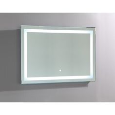 a bathroom mirror mounted on the wall above it's illuminated frame and backlit light