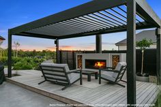 a patio with two chairs and a fire place