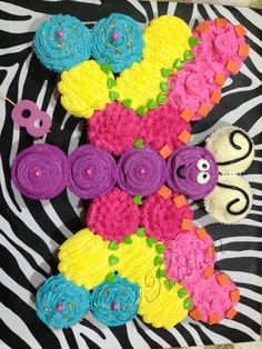 cupcakes are arranged in the shape of an x on a zebra print background